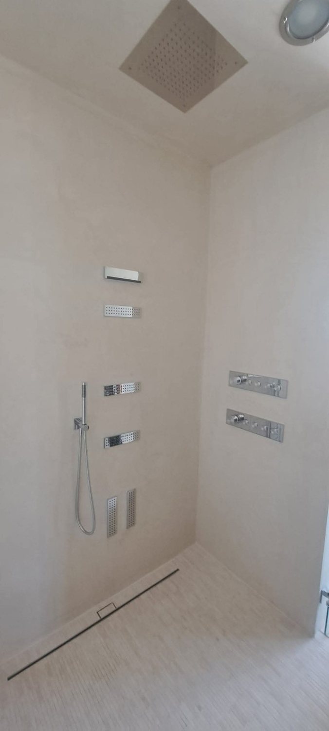 Modern custom shower with overhead rain head, body jets and handheld shower