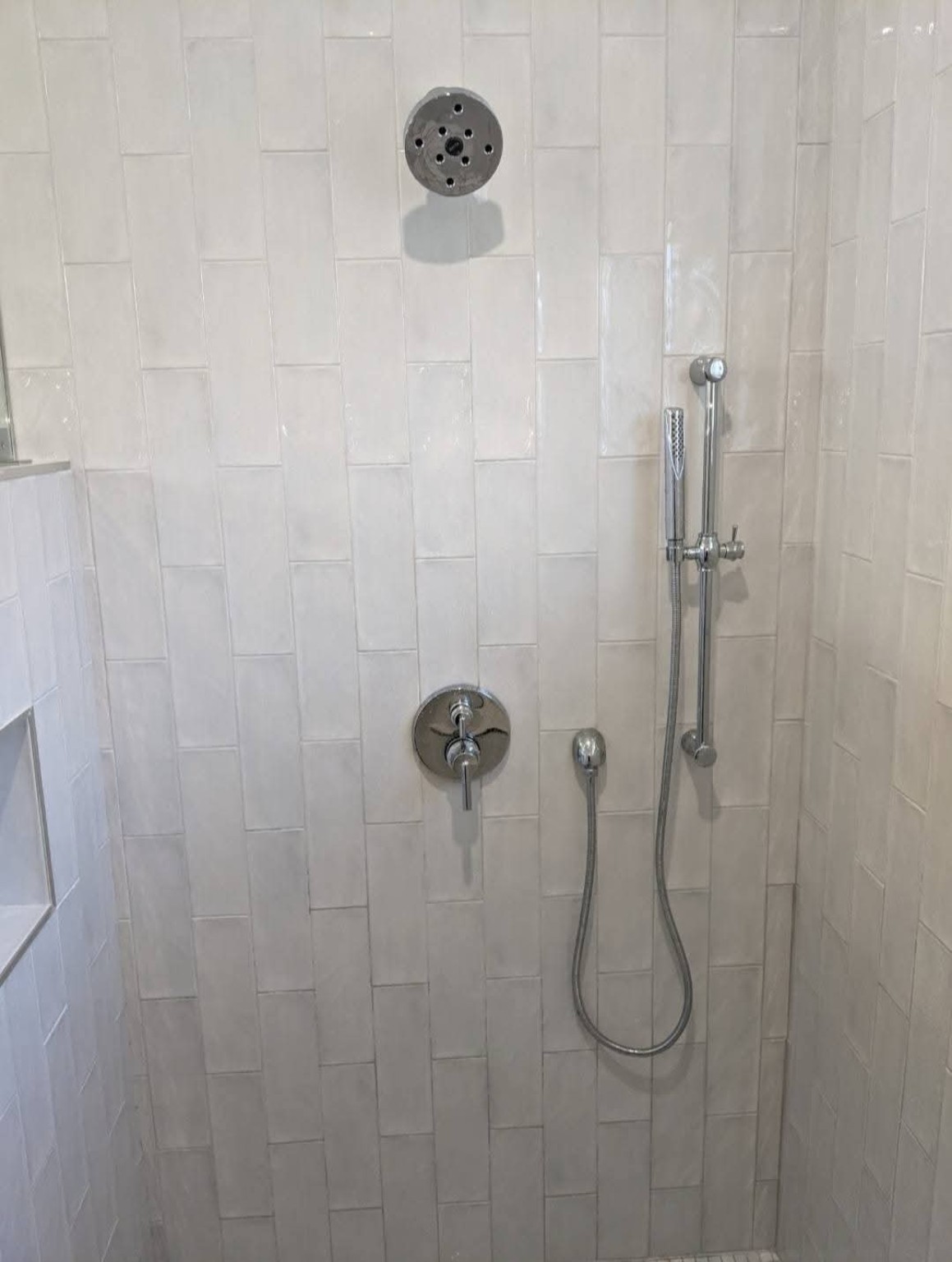 Tiled shower with rain shower head and handheld shower