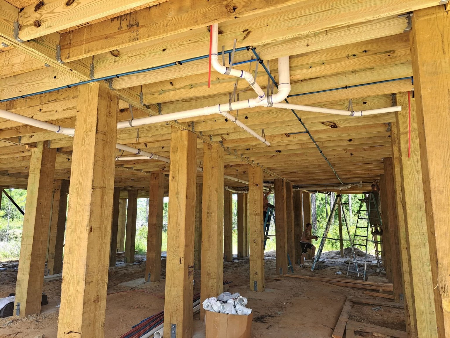 Water supply and drain piping installed beneath raised floor framing