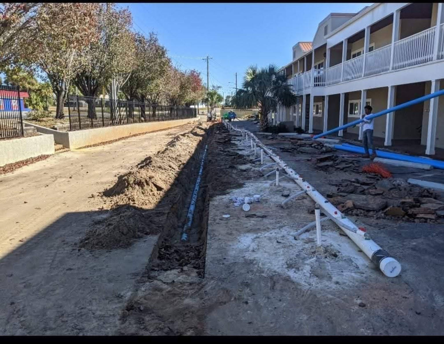 Excavated utility trench and underground piping at commercial property