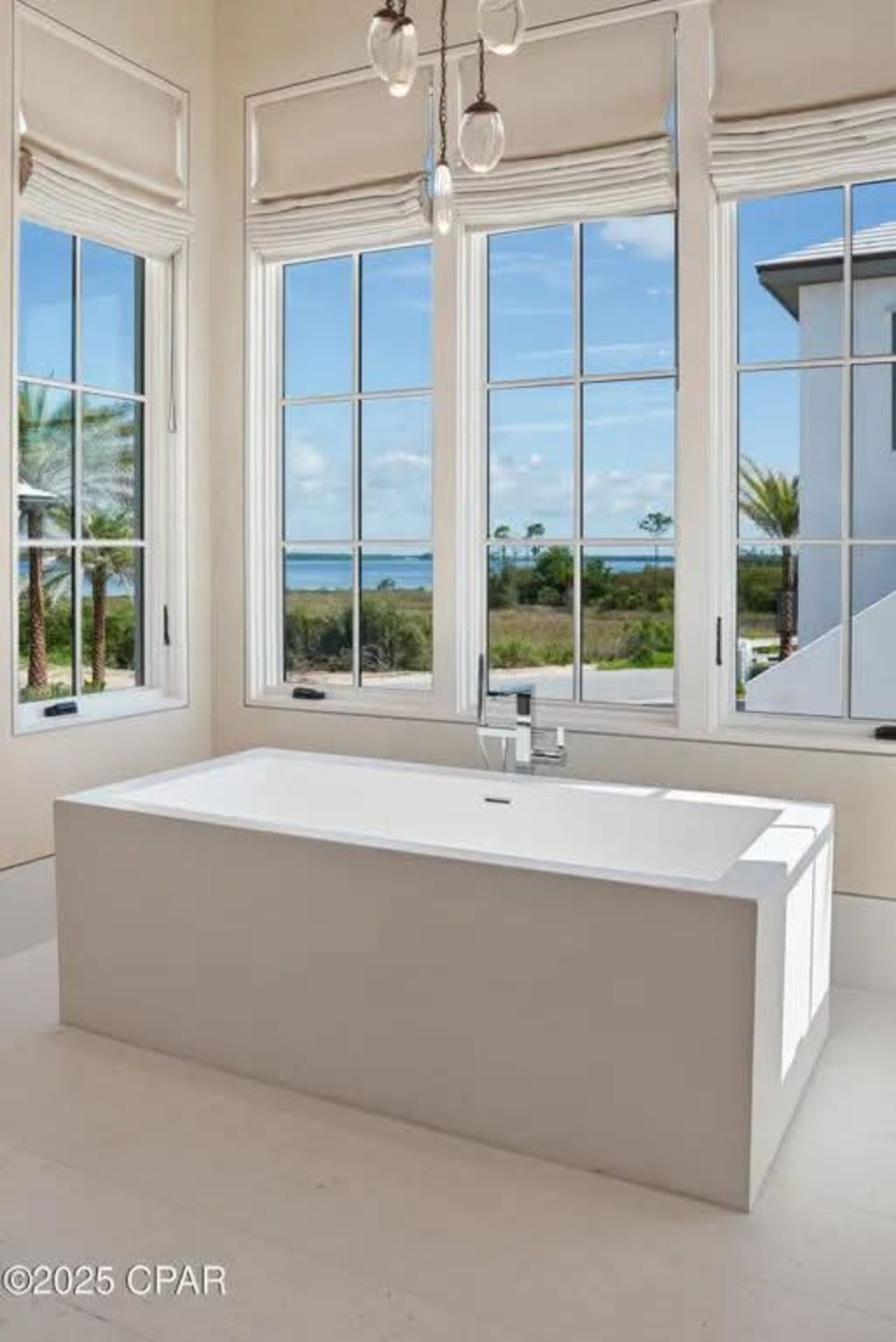 Contemporary freestanding tub with expansive coastal views